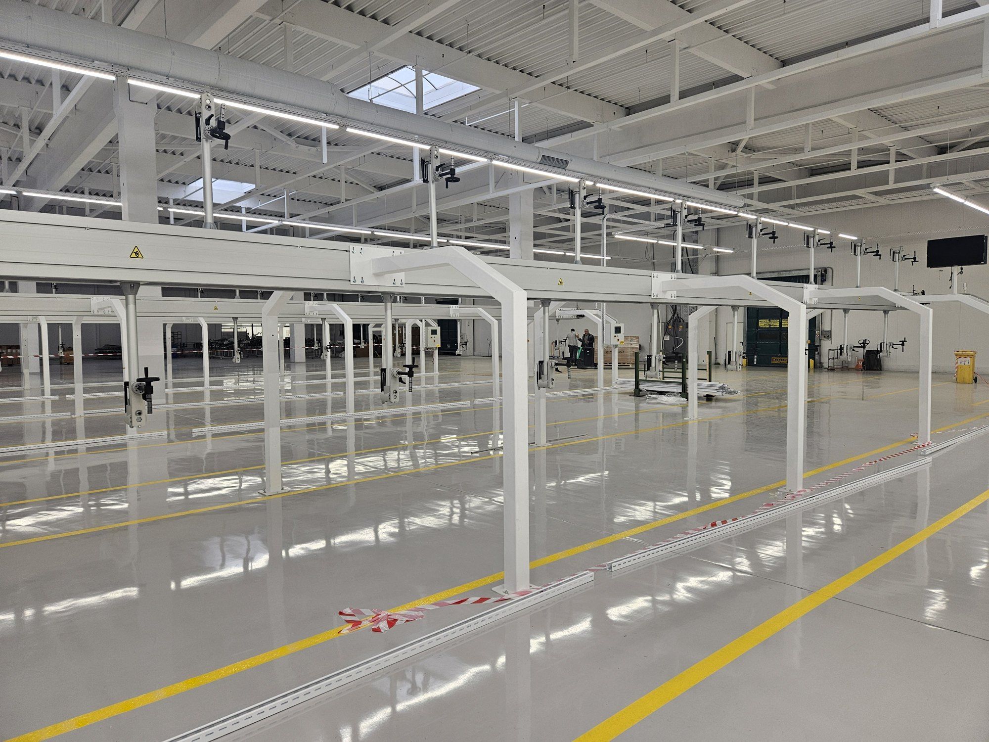 A newly installed line running the length of an empty white assembly hall